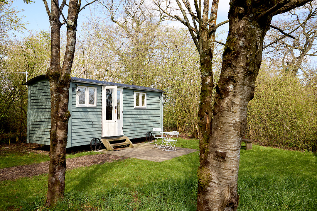 A shepherds hut in a private wooded area at Great Ashley Farm in Wiltshire