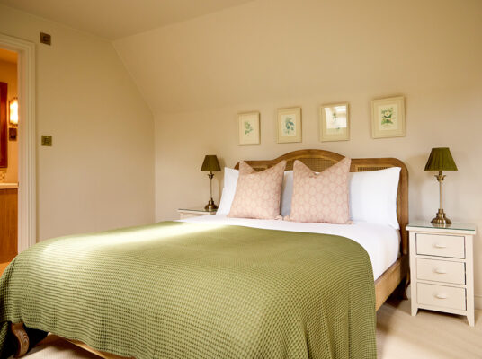 A corner view of the bed inside Wisteria, a holiday cottage in the countryside at Great Ashley Farm in Wiltshire