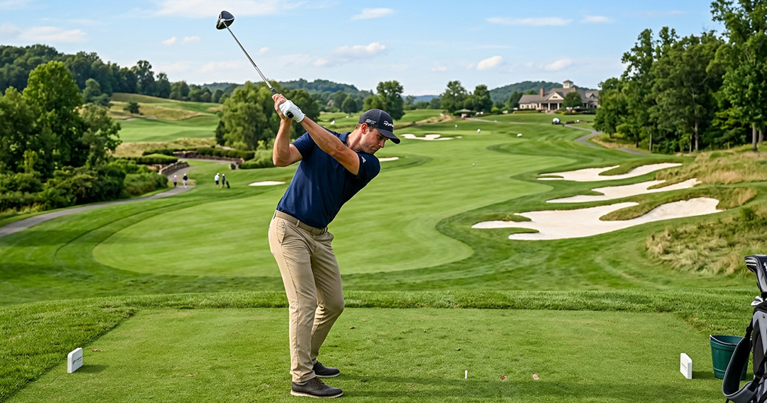 a male golfer wearing blue cap and blue golfing polo shirt hitting a tee shot with a driver